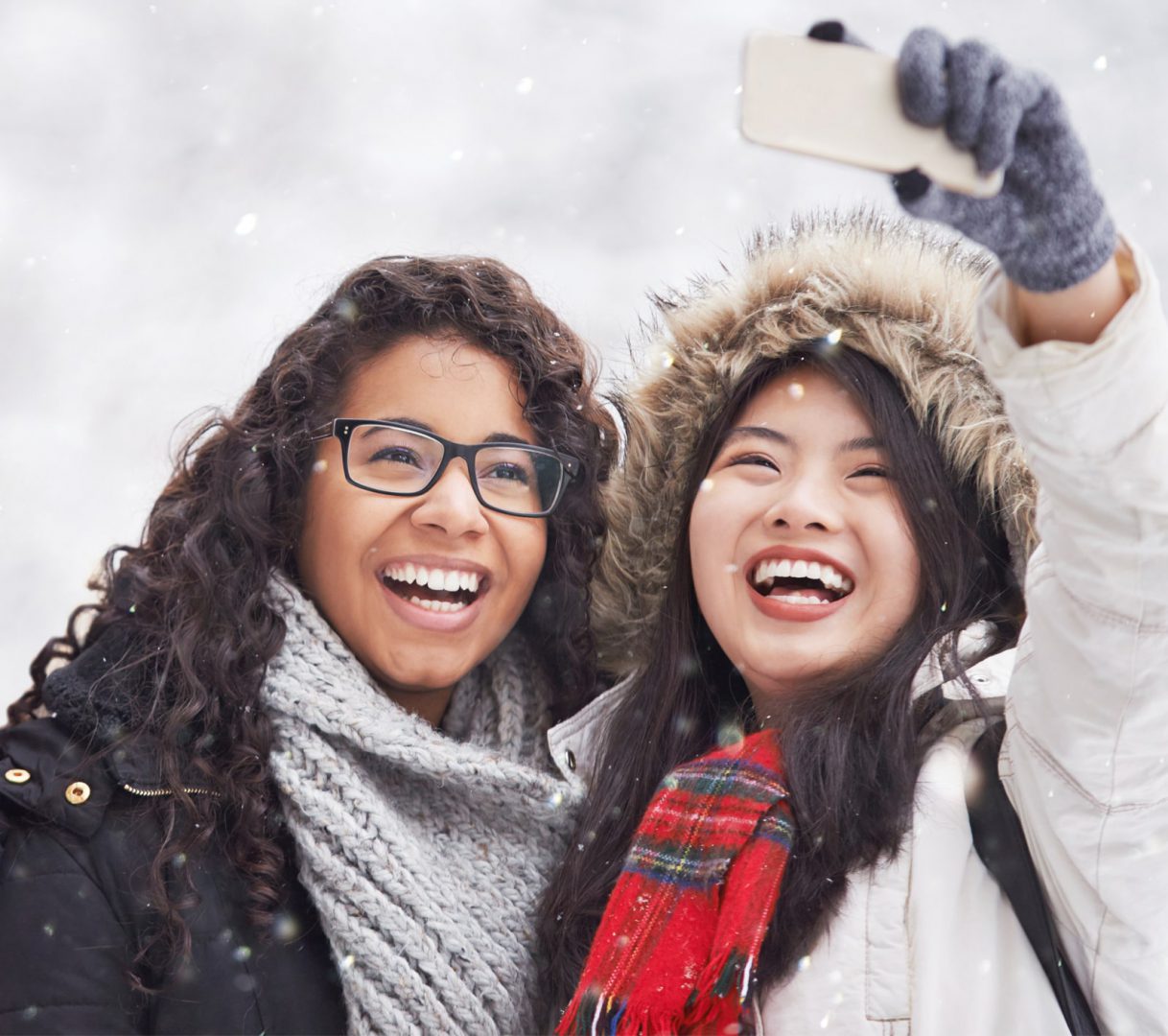 Two tourists taking a selfie while snowing